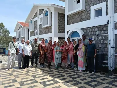 a group of people standing in front of a house at Longwood Resorts in Kotagiri