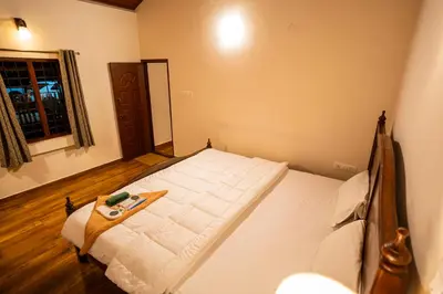 a bedroom with a large bed with a tray on it at Yaala - Coorg Riverside Retreat in Napoklu