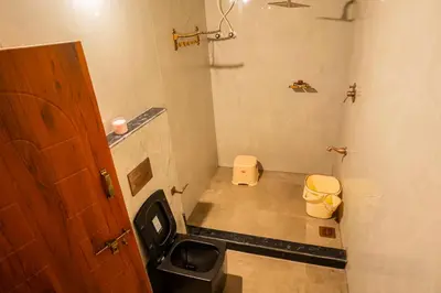 a small bathroom with a toilet and a sink at Yaala - Coorg Riverside Retreat in Napoklu