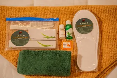 a kit of products with a green sponge and toothpaste at Yaala - Coorg Riverside Retreat in Napoklu