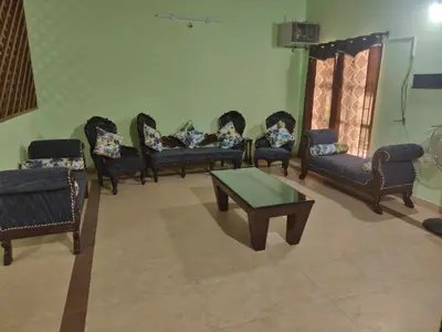 a group of chairs and a table in a room at Deep view luxury villa Coffee Cottage Coorg in Madikeri