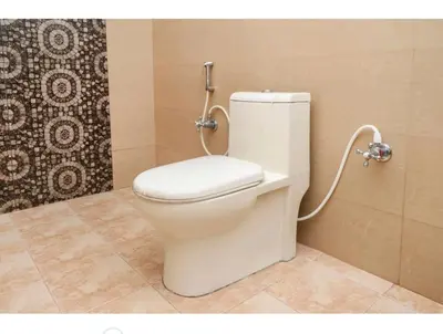 a white toilet in a bathroom with a shower at Deep view luxury villa Coffee Cottage Coorg in Madikeri