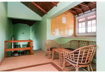 a room with a table and chairs and a window at Deep view luxury villa Coffee Cottage Coorg in Madikeri