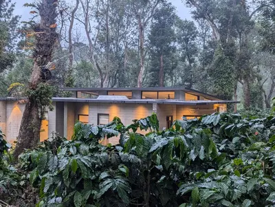 a house in the middle of a forest at Birdsong Luxury Pool Villa by Luxunlock Private Villas in Suntikoppa