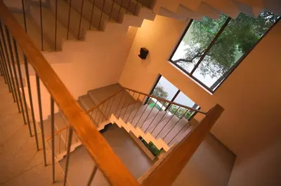 an overhead view of a staircase with two windows at RIVERSCAPES by NOORJEHAN in Palakkad