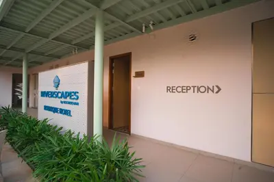 a building with a sign that reads reception at RIVERSCAPES by NOORJEHAN in Palakkad