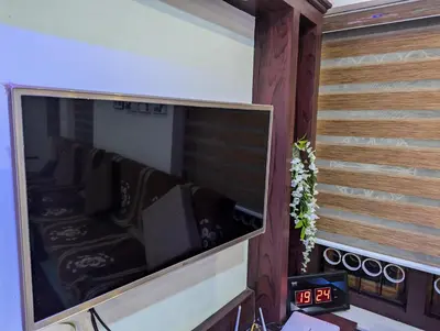a large flat screen tv on a wall at Nadavayal Villa in Wayanad