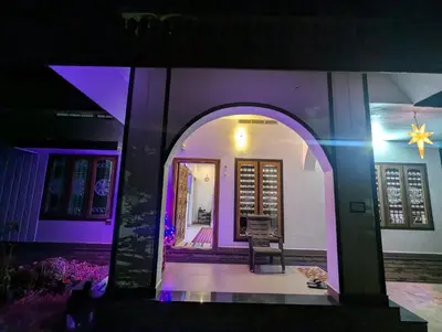 a house with an arched doorway with purple lights at Nadavayal Villa in Wayanad