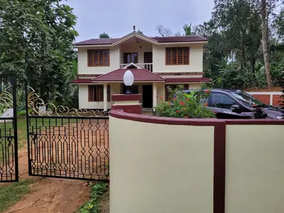 a house with a gate in front of it at Wayanad Villa homestay in Meenangadi