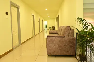 an empty hallway with a chair in a building at Cous Cous Residency Hotel in Padinjarathara