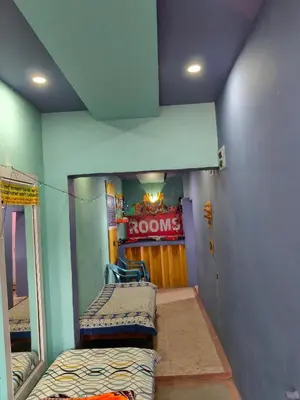 a room with two bunk beds in a house at Sri Vinayaka Tourist Home in Nanjangūd