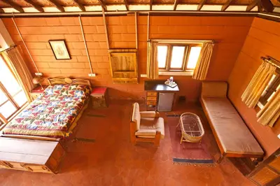 an overhead view of a room with a bed and benches at Kabbe Hillview Homestay in Madikeri
