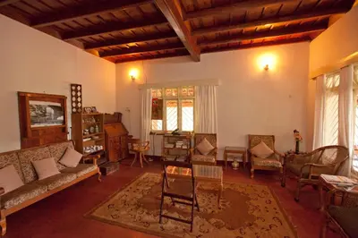 a living room with a couch and chairs at Kabbe Hillview Homestay in Madikeri