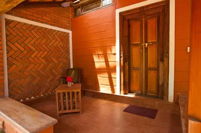 an empty room with a door and a wooden wall at Kabbe Hillview Homestay in Madikeri