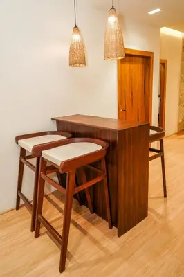 a wooden desk with two chairs and two lights at Virgin Valley Leisure Resort in Ooty