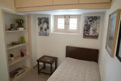 a small bedroom with a bed and a window at Perfect Gateway in Mysore