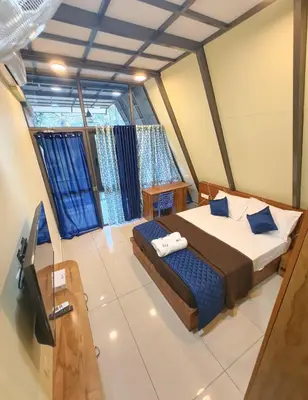 a bedroom with a large bed and a window at Goldenpeak Estate-Homestay-3Bed-A frame Holiday Home in Wayanad