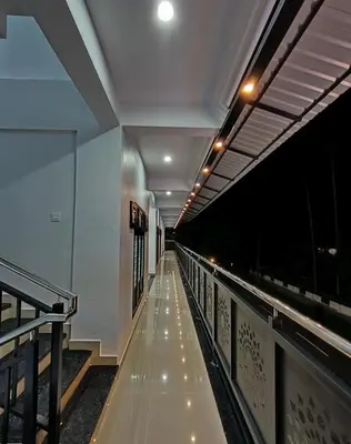a long hallway with lights on the side of a building at Achandy Arcade in Kakkadampoyil