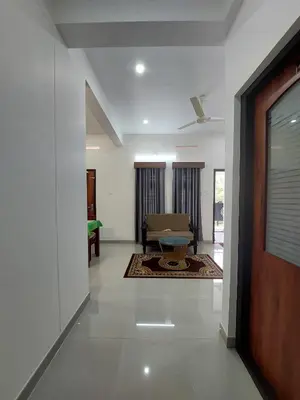 a hallway of a house with a living room at Achandy Arcade in Kakkadampoyil