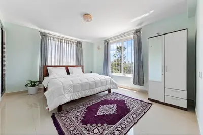 a bedroom with a bed and a purple rug at BVK Mount Home in Ketti