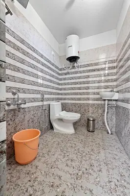 a bathroom with a toilet and a sink at BVK Mount Home in Ketti