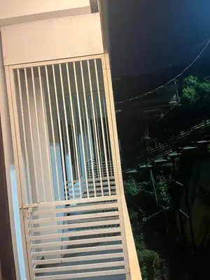 a sliding glass door with a view of a building at VARIYATH HOMESTAY THIRUNELLi in Thirunelli