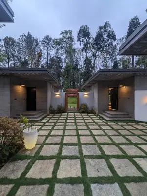a courtyard of a house with a stone floor at Earthsong Luxury Pool Villa by Luxunlock Private Villas in Suntikoppa