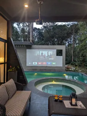 a swimming pool with a tv in a house at Earthsong Luxury Pool Villa by Luxunlock Private Villas in Suntikoppa