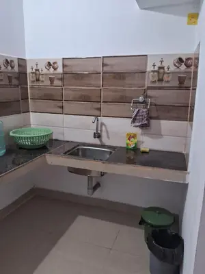 a kitchen with a sink and a counter at Shree Cottage in Madikeri