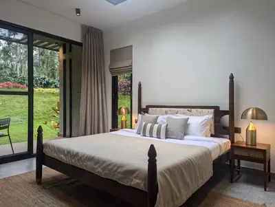 a bedroom with a large bed and a large window at Earthsong & Birdsong Luxury Pool Villa by Luxunlock Private Villas in Suntikoppa