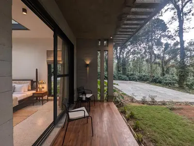 a house with a large glass door and a bedroom at Earthsong & Birdsong Luxury Pool Villa by Luxunlock Private Villas in Suntikoppa