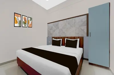 a bedroom with a large bed in a room at Townhouse Thondayad Calicut Formerly Dream Casa in Kakkayam