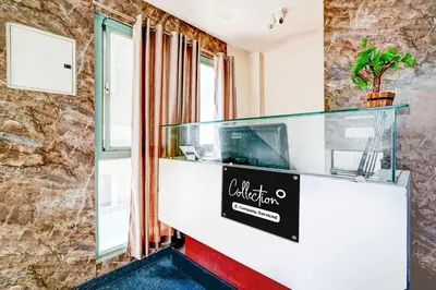 a aquarium in a room with a stone wall at Super Collection O Rajkumar Road Formerly Stone Villa in Narasimharaja Puram