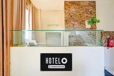 a hotel sign on the counter of a hotel room at Super Hotel O Kaveri Road Mysore in Mysore