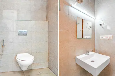 a bathroom with a toilet and a sink at Super Hotel O Kaveri Road Mysore in Mysore