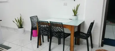 a dining room table and chairs with plants on it at Little home apartment in Kozhikode