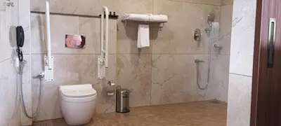 a bathroom with a shower and a toilet and a phone at Blue Diamond Residency in Perintalmanna