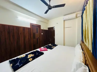 a bedroom with a bed and a ceiling fan at 1 BHK flat in Guruvayur - Sooryamadhavam Apartments-only for pilgrims in Guruvāyūr