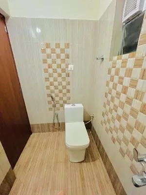 a bathroom with a toilet and a shower at 1 BHK flat in Guruvayur - Sooryamadhavam Apartments-only for pilgrims in Guruvāyūr