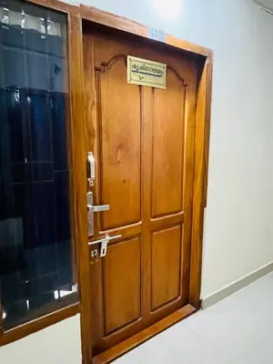 a wooden door with a sign on it at 1 BHK flat in Guruvayur - Sooryamadhavam Apartments-only for pilgrims in Guruvāyūr