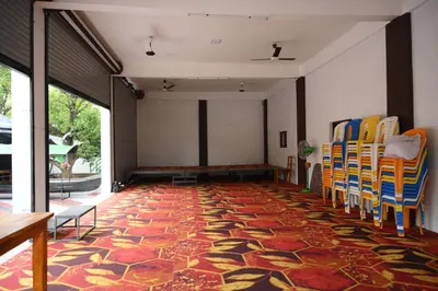 an empty room with chairs and a carpet at Sidharth Resort, Vadavannur in Kollengode