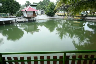 a pond of water with a small house in it at Sidharth Resort, Vadavannur in Kollengode