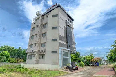 a tall building with motorcycles parked in front of it at Hotel J N Stay Mysore - 12 Minutes to Mysore Palace in Mysore