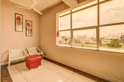 a waiting room with a window and a red stool at Hotel J N Stay Mysore - 12 Minutes to Mysore Palace in Mysore