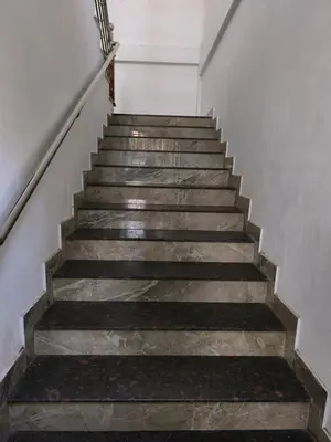 a set of stairs in a building at Serenity Home Stay in Sultan Bathery