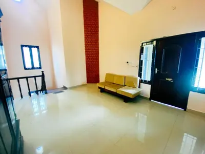a living room with a yellow couch in a room at Hilltown Villa Holiday's in Ooty