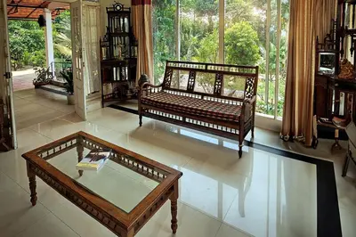 a living room with a couch and a coffee table at Vintage Coffee Estate 3 Bedrooms 1 Cottage in Wayanad