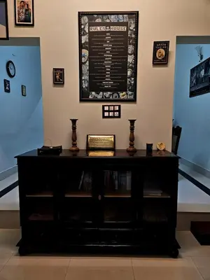 a black dresser in a room with a sign on the wall at Vintage Coffee Estate 3 Bedrooms 1 Cottage in Wayanad