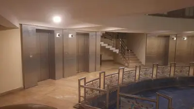 a staircase in a building with a swimming pool at Atlas Celestial Park in Nedumbassery