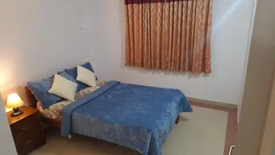 a small bedroom with a bed and a window at Atlas Celestial Park in Nedumbassery